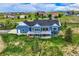 Aerial view of a large home with a wraparound porch on a lush lot in a suburban neighborhood at 41975 Muirfield Loop, Elizabeth, CO 80107