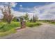 Exterior of home from street showing yard, mature trees, and brick mailbox at 41975 Muirfield Loop, Elizabeth, CO 80107