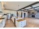 Modern kitchen with white cabinets, stainless steel appliances, and center island at 41975 Muirfield Loop, Elizabeth, CO 80107