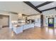 Bright kitchen featuring white cabinets, stainless steel appliances, and hardwood floors at 41975 Muirfield Loop, Elizabeth, CO 80107
