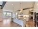 Stylish kitchen boasts stainless steel appliances, a large central island and wood floors at 41975 Muirfield Loop, Elizabeth, CO 80107