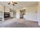 Open-concept living room with a fireplace, adjacent bar area, and recessed lighting at 41975 Muirfield Loop, Elizabeth, CO 80107