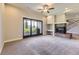 Spacious living room featuring a cozy fireplace and sliding glass doors to the outside at 41975 Muirfield Loop, Elizabeth, CO 80107