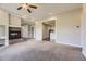 Open-concept living room with a brick fireplace and views into other living spaces at 41975 Muirfield Loop, Elizabeth, CO 80107