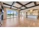Open-concept living space features stone fireplace, dark wood beams and large sliding doors to the outdoors at 41975 Muirfield Loop, Elizabeth, CO 80107