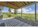 Covered patio with timber framing, a concrete slab, rocks, and beautiful backyard views at 41975 Muirfield Loop, Elizabeth, CO 80107