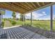 Covered patio with a view of the beautiful, expansive backyard and landscaping at 41975 Muirfield Loop, Elizabeth, CO 80107