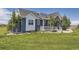 Beautiful home with a manicured lawn, a charming porch and lovely blue and white exterior paint at 41975 Muirfield Loop, Elizabeth, CO 80107