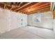 Unfinished basement with a concrete floor, exposed ceiling, and a small window at 5895 S Taft Ct # H, Littleton, CO 80127