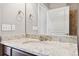 Bathroom with a granite countertop and a mirror reflecting an attached shower at 5895 S Taft Ct # H, Littleton, CO 80127