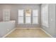 Elegant dining area with tiled floor, plantation shutters, and designer lighting at 5895 S Taft Ct # H, Littleton, CO 80127
