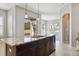 Modern kitchen island featuring granite countertops and backyard view at 5895 S Taft Ct # H, Littleton, CO 80127