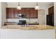 Kitchen island features granite countertops with modern appliances at 5895 S Taft Ct # H, Littleton, CO 80127