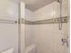 An all tile walk-in shower with built in seat and decorative tiling at 7877 S Ulster St, Centennial, CO 80112