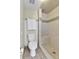 Tiled bathroom featuring a walk-in shower, toilet, and towel rack at 7877 S Ulster St, Centennial, CO 80112