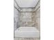 Stylish bathroom featuring a modern tub with a tiled surround and a shower with a rainfall showerhead at 7877 S Ulster St, Centennial, CO 80112