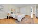 Bright bedroom featuring a cozy bed with decorative pillows, hardwood floors, and a stylish area rug at 7877 S Ulster St, Centennial, CO 80112