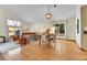 Well-lit dining area showcasing a view of the living room, wood floors, and modern light fixture at 7877 S Ulster St, Centennial, CO 80112