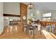 Charming dining room featuring a brick fireplace, wood floors and modern decor with view to a cozy living area at 7877 S Ulster St, Centennial, CO 80112