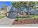 Charming two-story home with gray siding, brick accents, a mature tree, and a well-manicured lawn at 7877 S Ulster St, Centennial, CO 80112