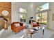 Cozy living room with a brick fireplace, vaulted ceilings, and large windows offering natural light at 7877 S Ulster St, Centennial, CO 80112