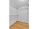 Walk-in closet space with shelving and hardwood floor at 7877 S Ulster St, Centennial, CO 80112