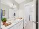Bright bathroom featuring a white vanity, neutral walls, and a view into an adjacent space at 2007 S Balsam St, Lakewood, CO 80227