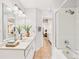 Bathroom with vanity, bathtub with shower, and neutral tile flooring at 2007 S Balsam St, Lakewood, CO 80227