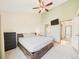 Large bedroom with a ceiling fan, neutral tones, and an en-suite bathroom, creating a peaceful retreat at 2007 S Balsam St, Lakewood, CO 80227