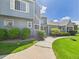 Charming two-story home features a walkway leading to the front door, surrounded by lush green landscaping at 2007 S Balsam St, Lakewood, CO 80227