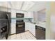 Functional kitchen features white cabinets and black appliances, offering a clean and modern cooking space at 2007 S Balsam St, Lakewood, CO 80227