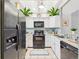 Efficient kitchen with white cabinetry, black appliances, and ample counter space, ideal for cooking at 2007 S Balsam St, Lakewood, CO 80227