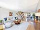 Bright living room with hardwood floors, a comfortable sofa, and a dining area, perfect for entertaining at 2007 S Balsam St, Lakewood, CO 80227