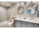 Modern bathroom with double vanity, grey cabinets, and a large walk-in shower at 3205 Quivas St, Denver, CO 80211