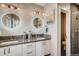 Double vanity bathroom with modern lighting and a walk-in shower at 3205 Quivas St, Denver, CO 80211