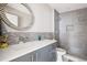 Contemporary bathroom featuring a single vanity, grey cabinets, and a shower/tub combo at 3205 Quivas St, Denver, CO 80211