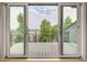 Private deck with sliding glass doors, offering views of the cityscape and trees at 3205 Quivas St, Denver, CO 80211