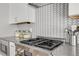 Modern kitchen with stainless steel appliances and geometric backsplash at 3205 Quivas St, Denver, CO 80211