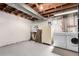 Unfinished basement with washer, dryer, shelving, and access for easy storage at 5833 S Pearl St, Centennial, CO 80121