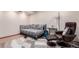 Inviting finished basement area, cozy couch, chair, and stylish rug creating a comfortable retreat at 5833 S Pearl St, Centennial, CO 80121