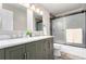 Modern bathroom featuring double sinks, decorative tile, and shower with glass doors at 5833 S Pearl St, Centennial, CO 80121