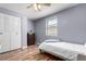 Cozy bedroom with wood floors, closet with doors, and a large window providing natural light at 5833 S Pearl St, Centennial, CO 80121