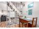 Dining area with a wood table and chairs next to an open staircase at 5833 S Pearl St, Centennial, CO 80121