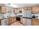 Well-lit kitchen features wood cabinets, stainless steel appliances and granite countertops at 5833 S Pearl St, Centennial, CO 80121