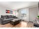 Inviting living room with plush seating, a coffee table, and a view of the outdoors at 5833 S Pearl St, Centennial, CO 80121