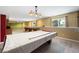 Finished basement space with pool tables, great lighting, and kitchenette at 21690 Longs Peak Ln, Parker, CO 80138