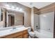 Bathroom with shower and tub combo plus vanity with sink and lighting at 21690 Longs Peak Ln, Parker, CO 80138