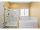 Bright bathroom featuring a glass shower, a large tub and window, and tile floors at 21690 Longs Peak Ln, Parker, CO 80138