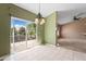 Dining area featuring tile flooring, view to deck, and modern lighting fixture at 21690 Longs Peak Ln, Parker, CO 80138