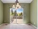 Dining area featuring tile flooring, decorative lighting and sliding doors to the deck at 21690 Longs Peak Ln, Parker, CO 80138